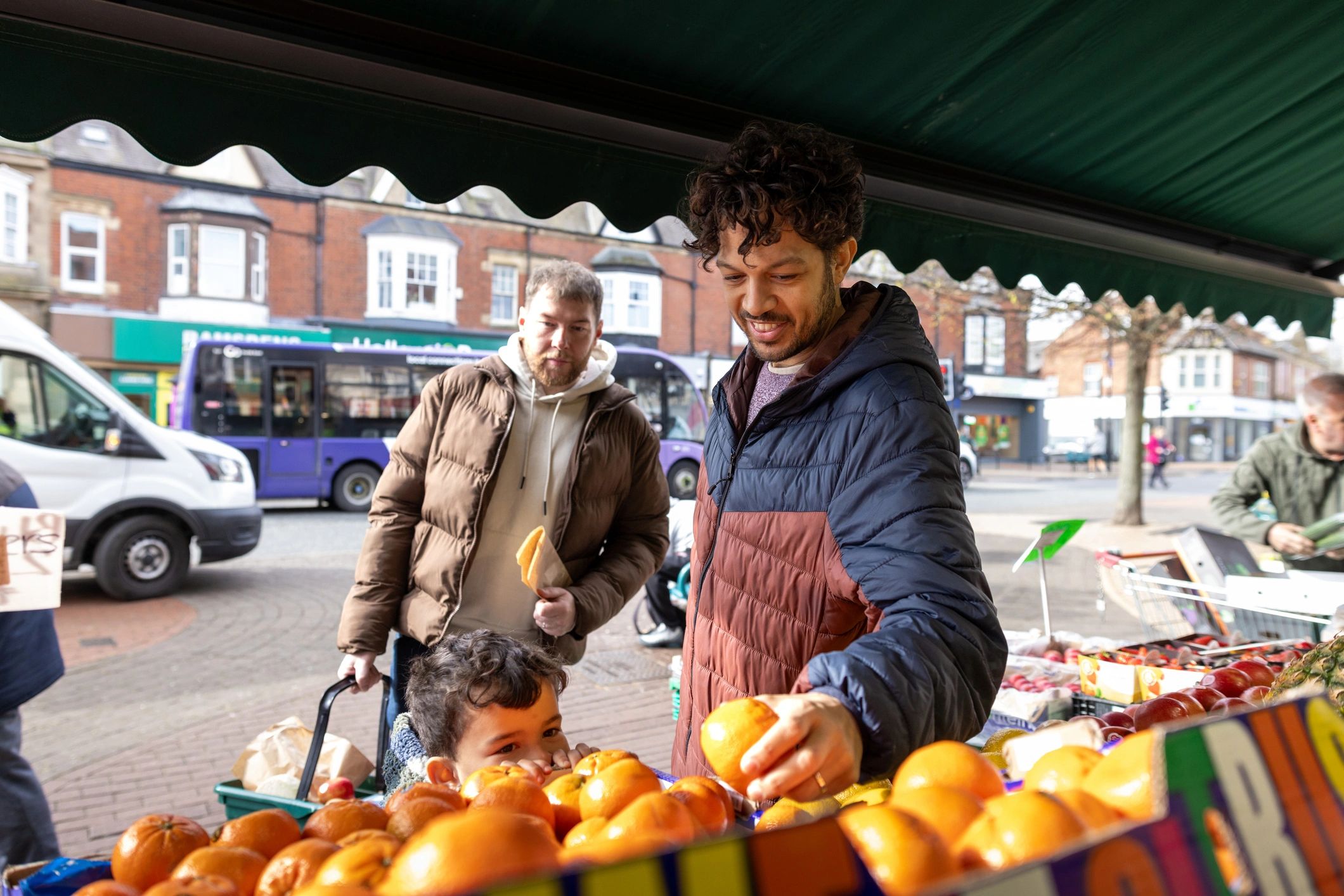 Shoppers visiting a fruit and vegetable stand