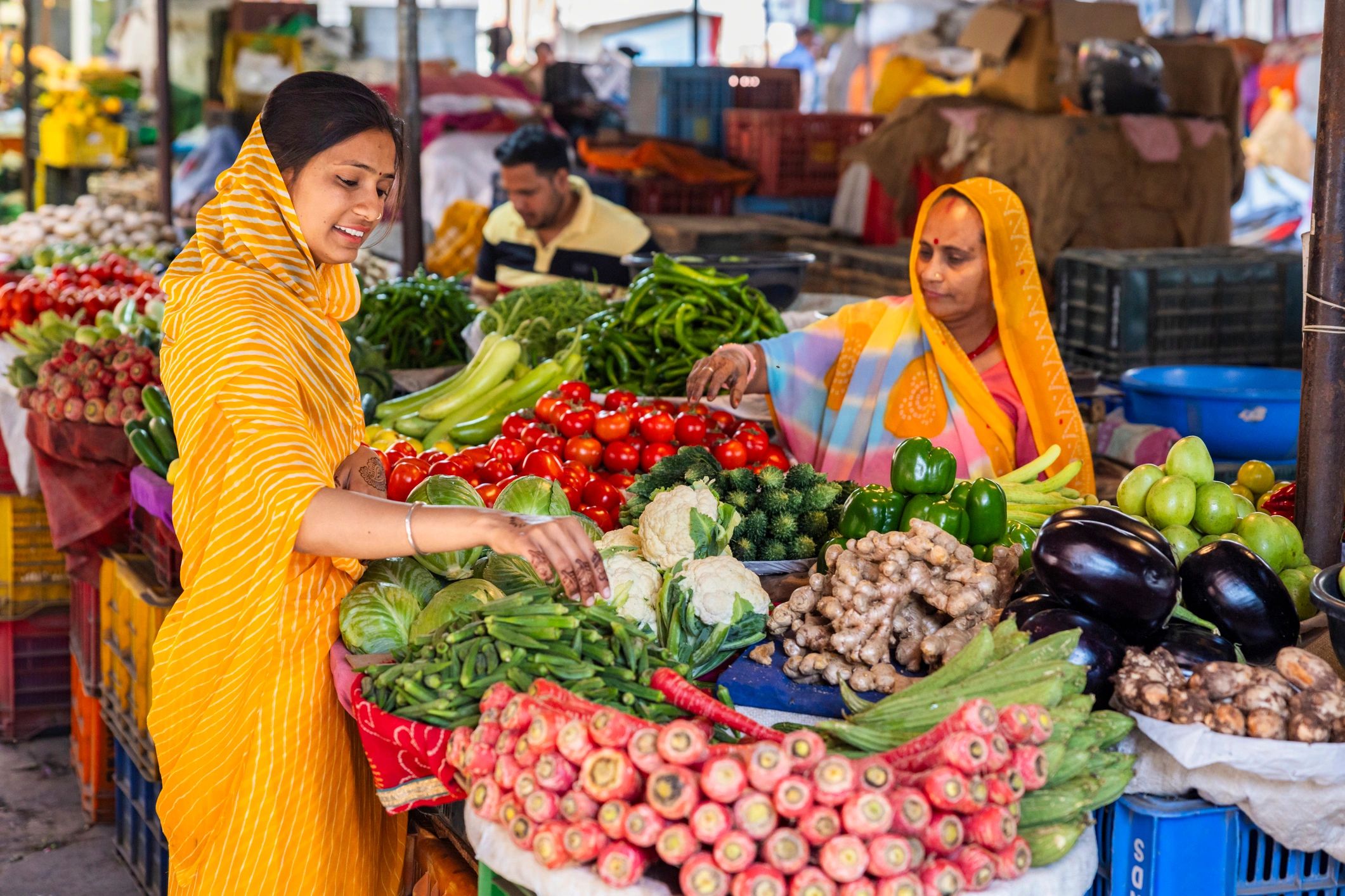 Fresh vegetables displayed at a busy market stall